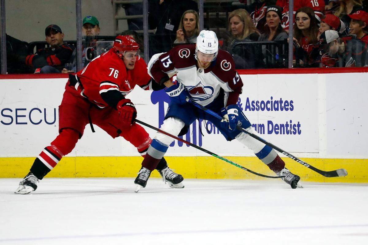 Carolina Hurricanes’ Brady Skjei (76) defends against Colorado Avalanche’s Valeri Nichushkin (13) during the second period of an NHL hockey game in Raleigh, N.C., Thursday, March 10, 2022. (AP Photo/Karl B DeBlaker)