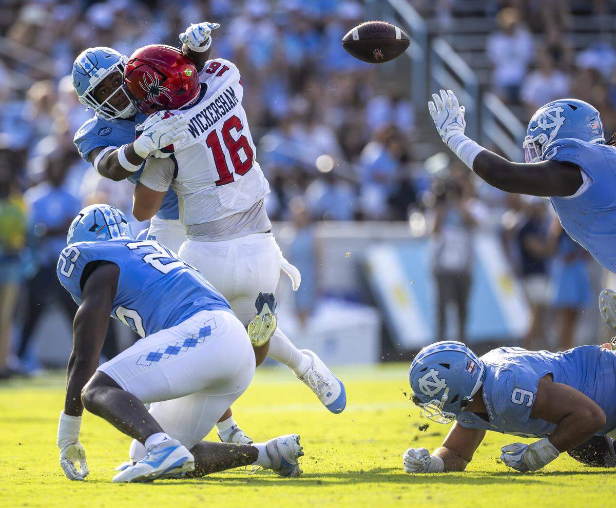 North Carolina linebacker Mikia Gbayor (4) sacks Richmond quarterback Kyle Wickersham (16) and forces a fumble in the third quarter on Saturday, September 13, 2025 at Kenan Stadium in Chapel Hill, N.C.