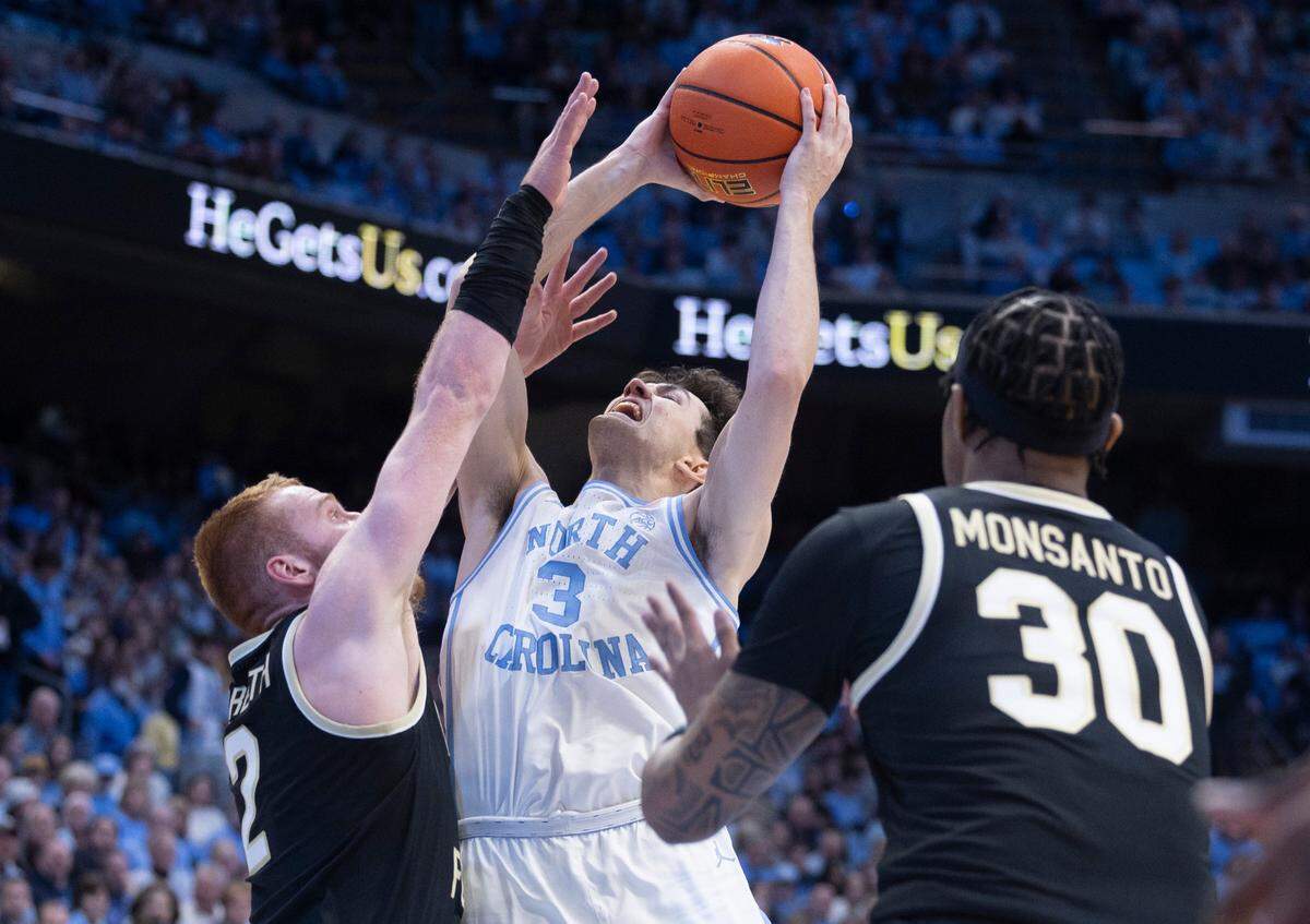 North Carolina’s Cormac Ryan (3) puts up a shot against Wake Forest’s Cameron Hildreth (2) during the first half on Monday, January 22, 2024 at the Smith Center in Chapel Hill, N.C.