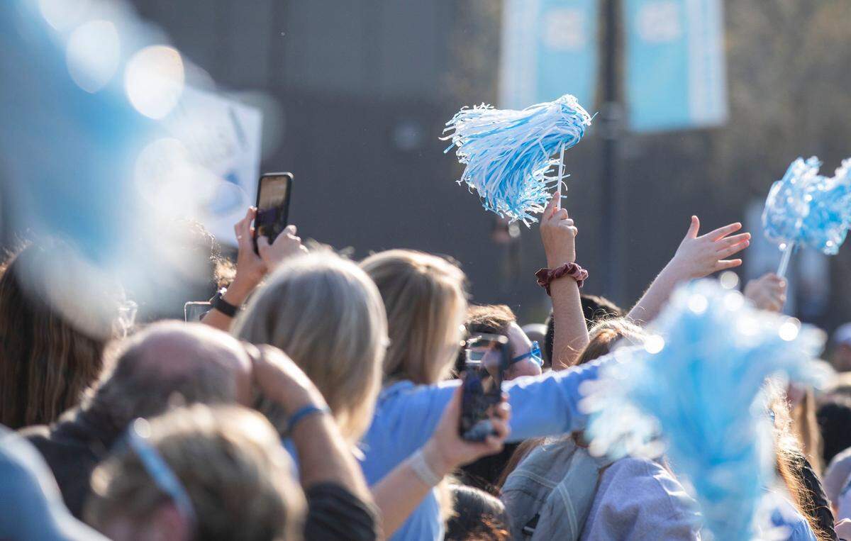 UNC men’s basketball fans celebrate their team as they start their journey to the Final Four in New Orleans outside the Dean Dome in Chapel Hill, N.C. on Wednesday, March 30, 2022.