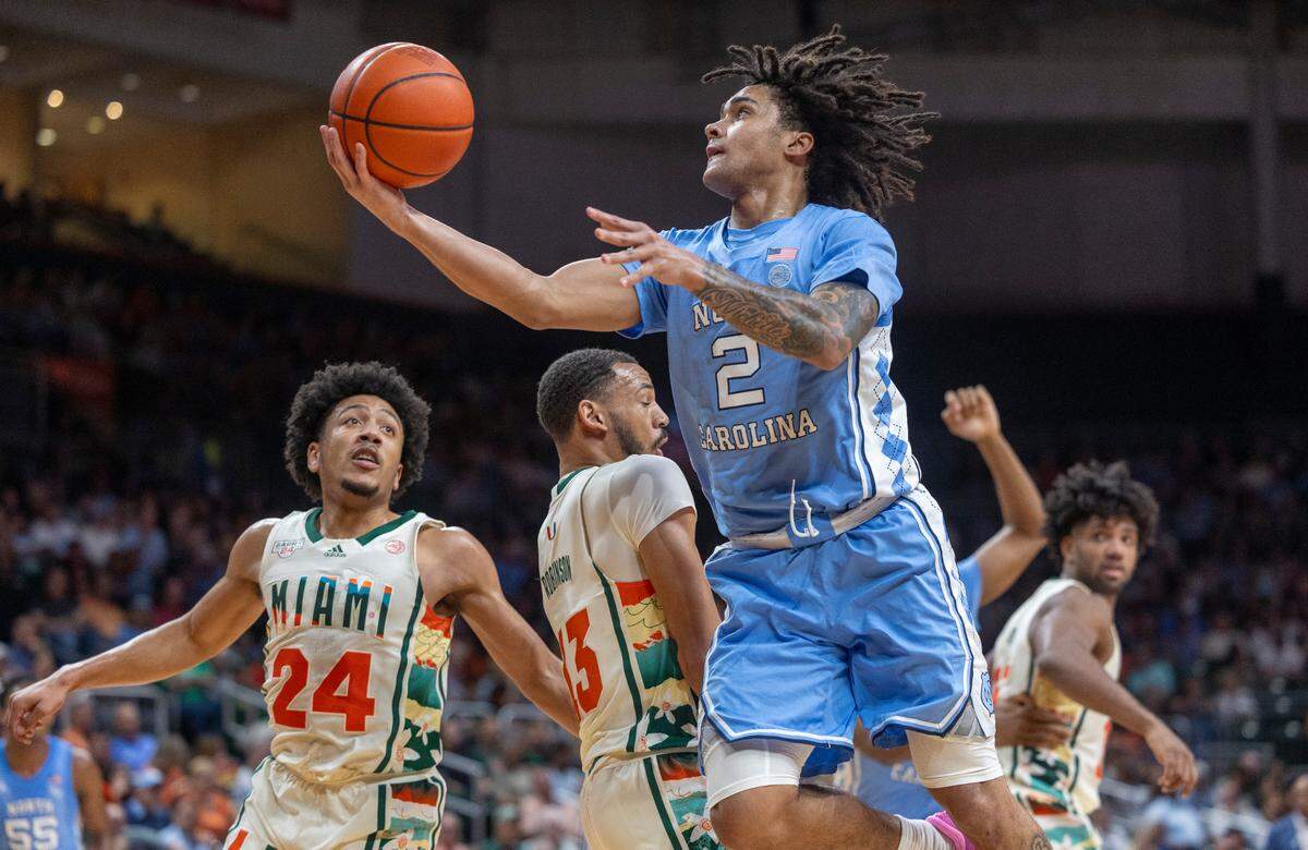 North Carolina’s Elliot Cadeau (2) drives to the basket against Jakai Robinson (13) in the first half on Saturday, February 10, 2024 at the Watsco Center in Coral Gables, Florida. Cadeau scored 11 points in the first half.