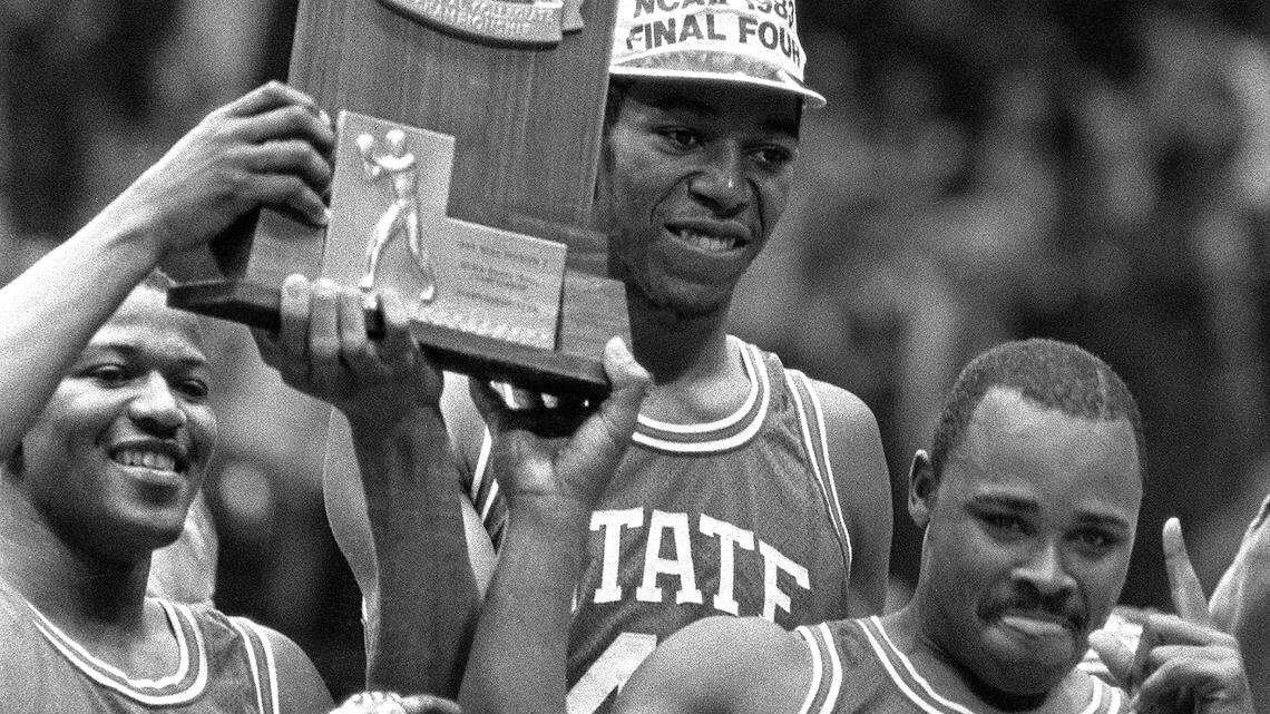 N.C. State’s Derrick Whittenburg, left, Thurl Bailey, and Sidney Lowe hoist the 1983 NCAA Championship trophy after the Wolfpack defeated Houston to win the National championship on April 5, 1983.