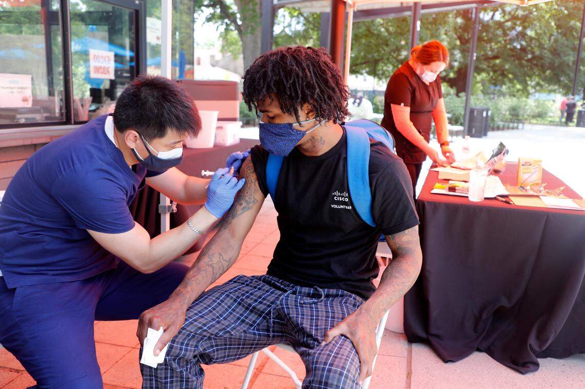Jae Jung with inClinic RX prepares to give Torres Milton of Raleigh a COVID-19 vaccine shot during a free vaccine clinic in Moore Square in downtown Raleigh, N.C. Tuesday, May 4, 2021. The clinic, sponsored by Eastern Carolina Medical Center, inClinic RX, Avance Care and Empire Eats, will be open from noon to 5 Tuesday May 4th through Friday May 7th.