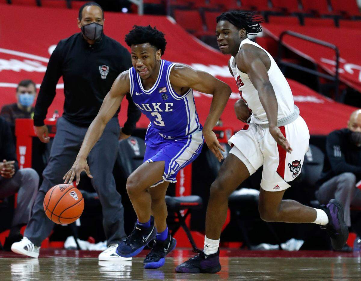 Duke’s Jeremy Roach (3) brings the ball up court trailed by N.C. State’s Cam Hayes (3) during the second half of Duke’s 69-53 victory over N.C. State at PNC Arena in Raleigh, N.C., Saturday, February 13, 2021.
