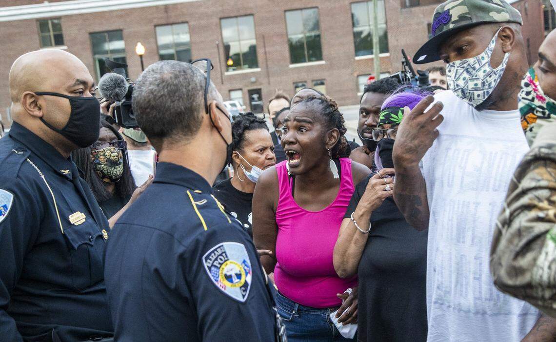 Demonstrators talk with Elizabeth City Police Chief Eddie Buffaloe, Jr. outside the Pasquotank County Public Safety Building in downtown Elizabeth City, NC Wednesday, April 21, 2022. A Pasquotank County sheriff’s deputy shot and killed Andrew Brown Jr., who is Black, on April 21, 2021 in Elizabeth City, North Carolina. Officials say they were executing a search warrant about 8:30 a.m. on Perry Street. The shooting is under review by the State Bureau of Investigation.