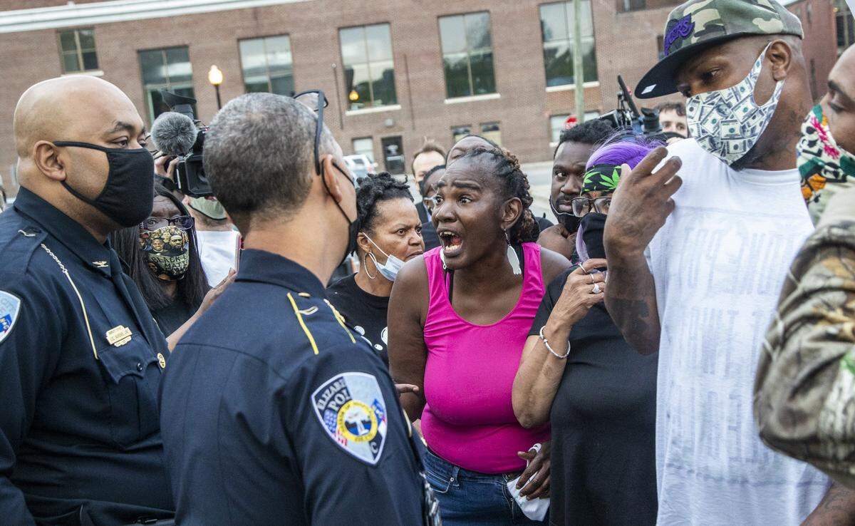 Demonstrators talk with Elizabeth City Police Chief Eddie Buffaloe, Jr. outside the Pasquotank County Public Safety Building in downtown Elizabeth City, NC Wednesday, April 21, 2022. A Pasquotank County sheriff’s deputy shot and killed Andrew Brown Jr., who is Black, on April 21, 2021 in Elizabeth City, North Carolina. Officials say they were executing a search warrant about 8:30 a.m. on Perry Street. The shooting is under review by the State Bureau of Investigation.