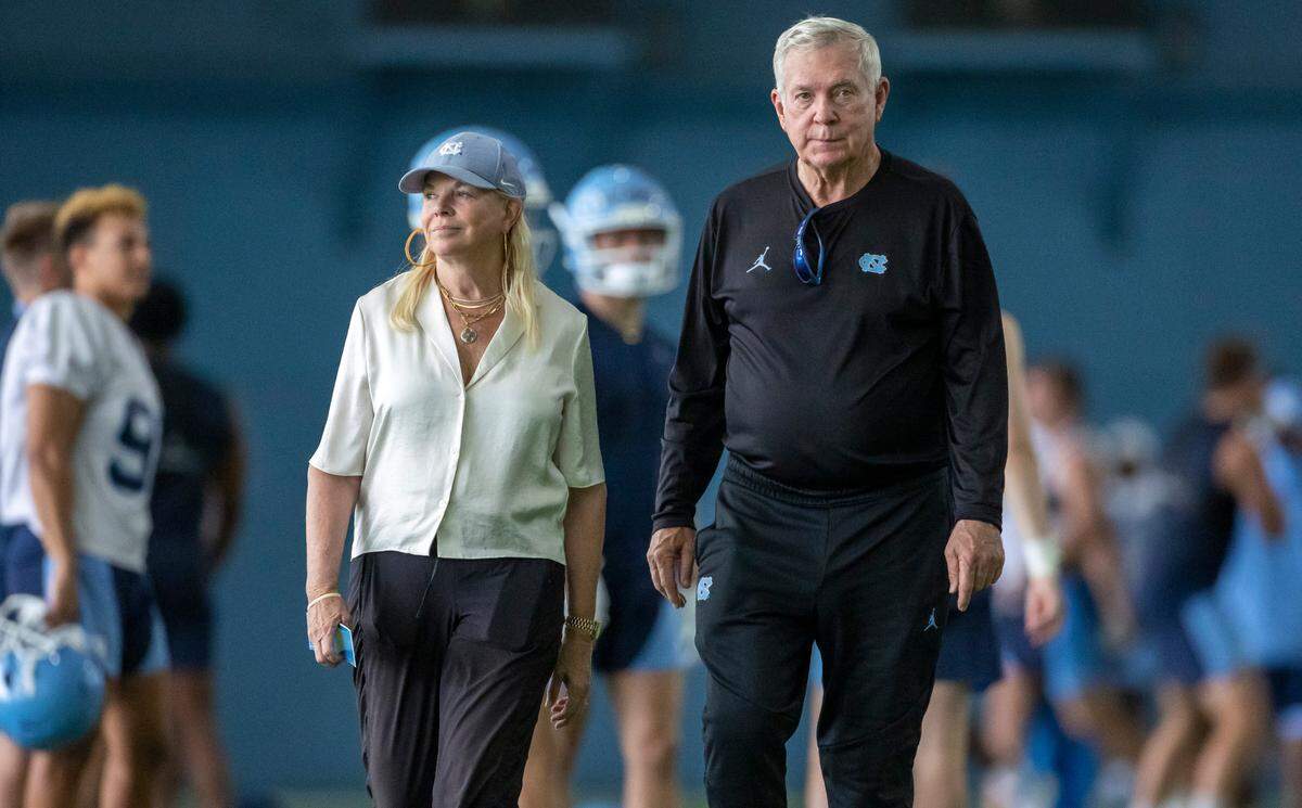 North Carolina coach Mack Brown and his wife Sally walk together across the practice field at the conclusion of the Tar Heels’ first practice of the season on Wednesday, August 2, 2023 in Chapel Hill, N.C.