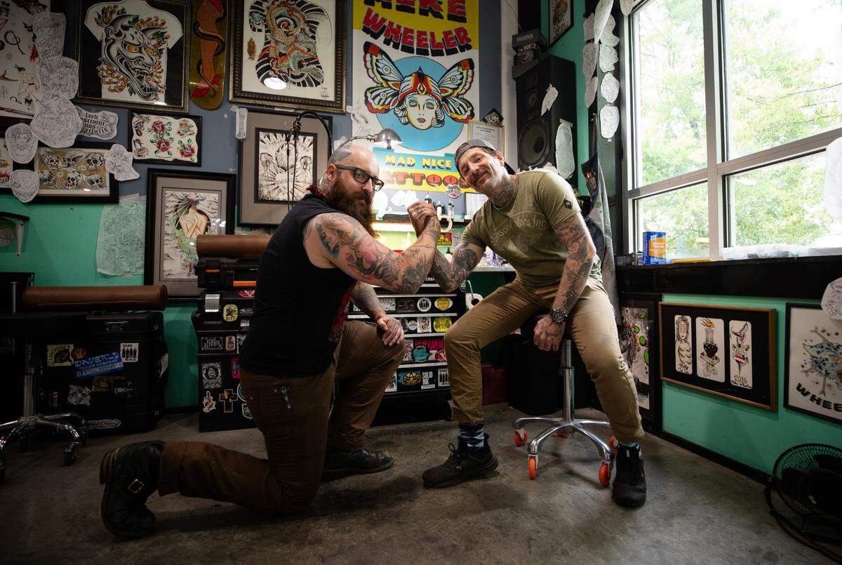 Tattooers Max Shafer, left, and Mike Wheeler, right, pose for a portrait at Easy Tiger Custom Tattoo in Durham, N.C. on Wednesday, June 21, 2023. Wheeler opened the shop in 2018.