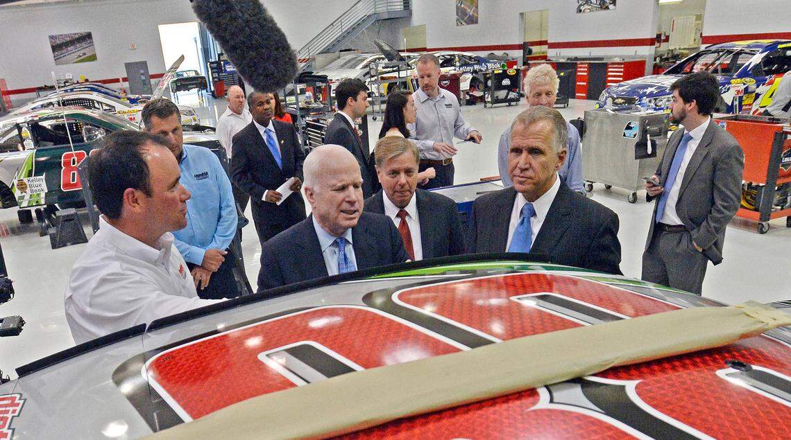 Marshall Carson, President of Hendrick Motorsports, makes a stop at Dale Earnhardt, Jr’s car while giving a tour of the race shop of Jimmie Johnson and Dale Earnhardt, Jr with U.S. Sen. John McCain of Arizona, center, left, U.S. Sen. Lindsey Graham of South Carolina, and Republican U.S. Senate candidate Thom Tillis of North Carolina in October 2014.