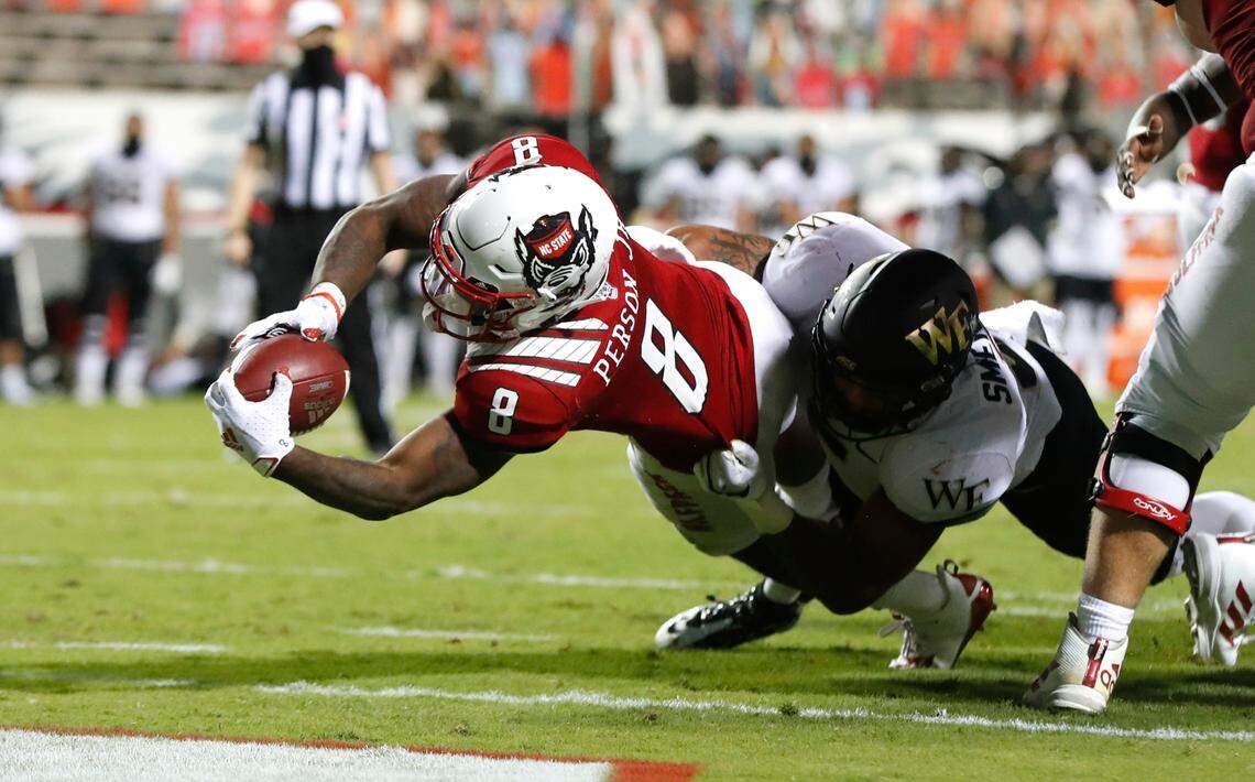 N.C. State running back Ricky Person Jr. (8) scores on a three-yard touchdown run as Wake Forest linebacker Ryan Smenda Jr. (5) defends during the second half of N.C. State’s 45-42 victory over Wake Forest at Carter-Finley Stadium in Raleigh, N.C, Saturday, Sept. 19, 2020.