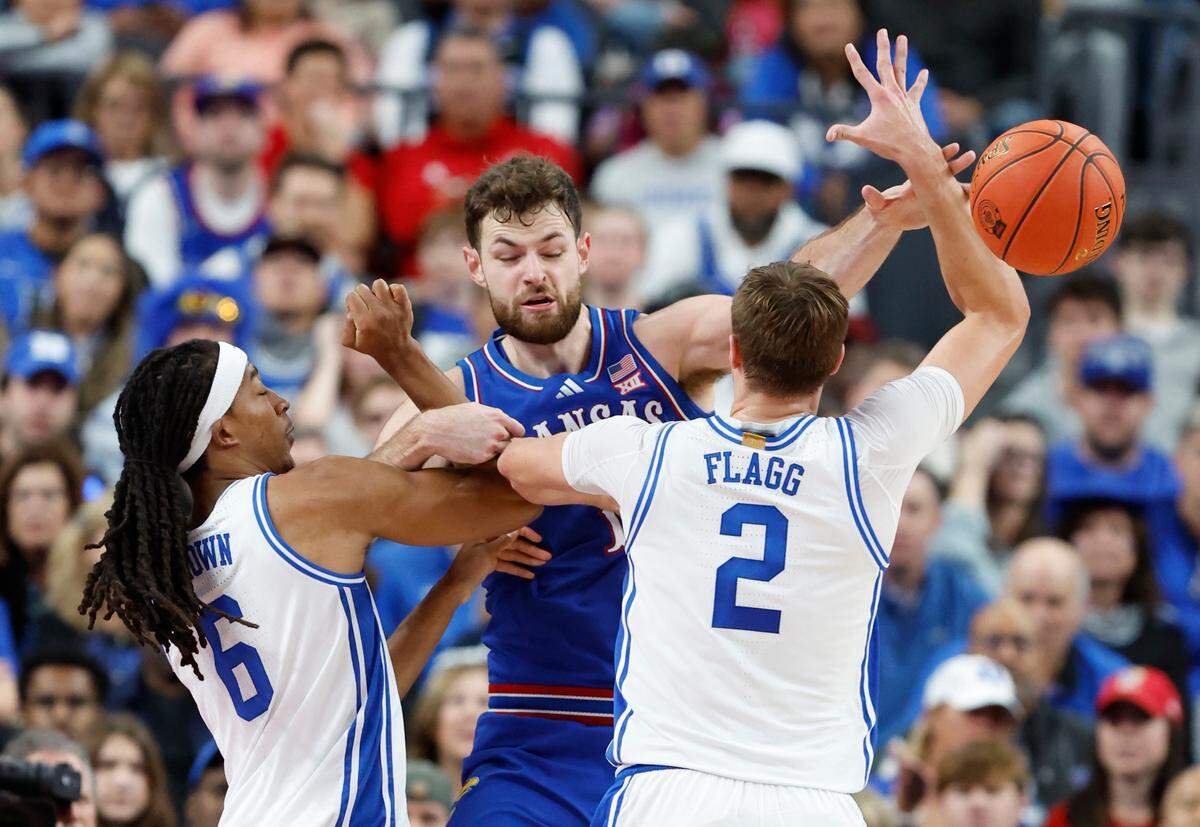 Duke’s Maliq Brown (6) and Duke’s Cooper Flagg defend Kansas’ Hunter Dickinson (1) during the first half of Duke’s game against Kansas in the Vegas Showdown at T-Mobile Arena in Las Vegas, Nev., Tuesday, Nov. 26, 2024.