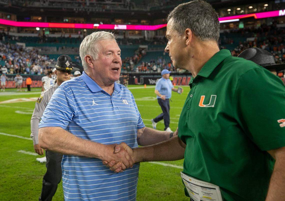 Miami coach Mario Cristobal congratulates North Carolina coach Mack Brown following the Tar Heels’ 27-24 victory on Saturday, October 8, 2022 at Hard Rock Stadium in Miami Gardens, Florida.