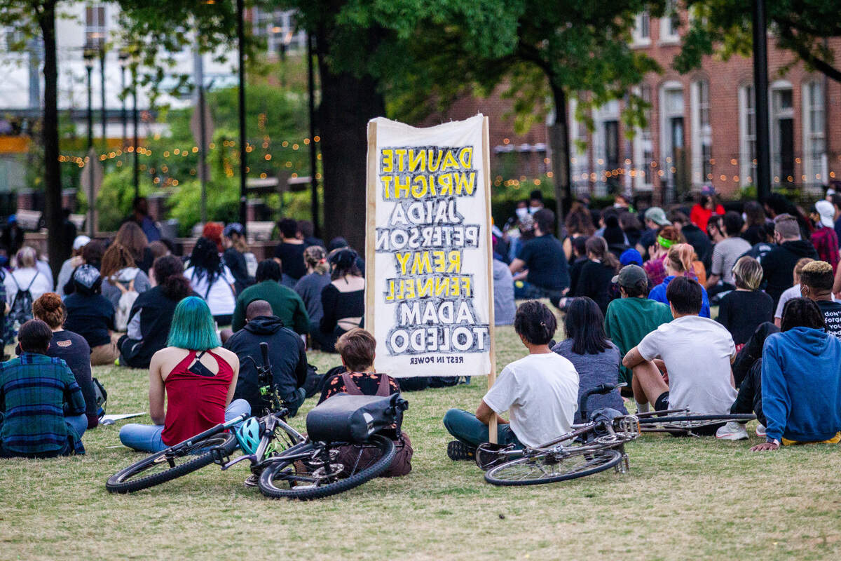 Demonstrators hold a vigil for Daunte Wright and others killed by police Sunday, April 18, 2021 in Moore Square.