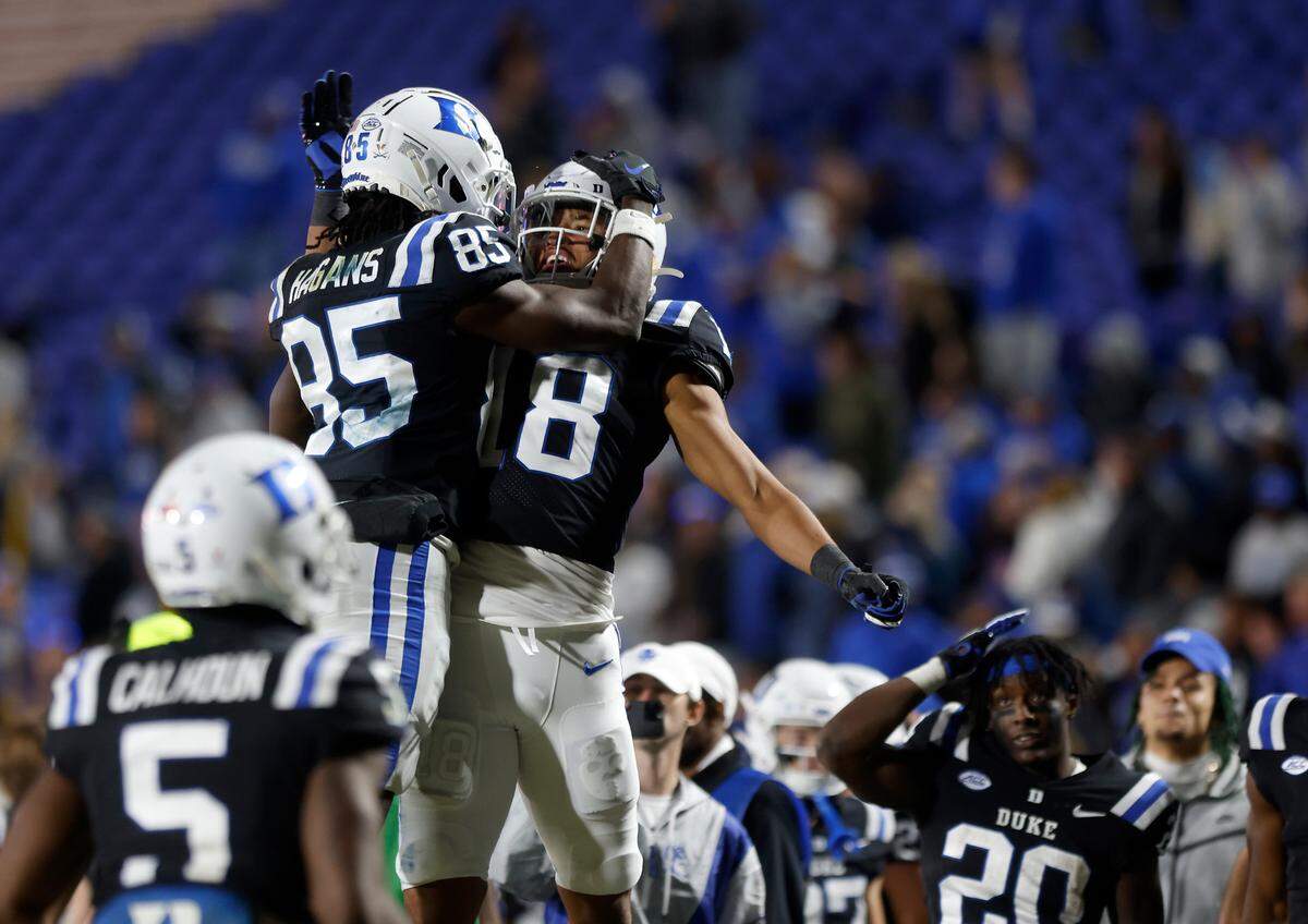 Duke’s Sahmir Hagans celebrates with Malik Bowen-Sims after scoring a touchdown to give the Blue Devils the lead over Wake Forest during the second half of Duke’s final regular season game at Wallace Wade Stadium on Saturday, Nov. 26, 2022, in Durham, N.C.