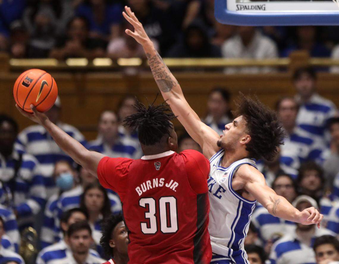 Duke’s Dereck Lively II pressures N.C. State’s D.J. Burns Jr. during the second half of Duke’s 71-67 win over N.C. State on Tuesday, Feb. 28, 2023, at Cameron Indoor Stadium in Durham, N.C.
