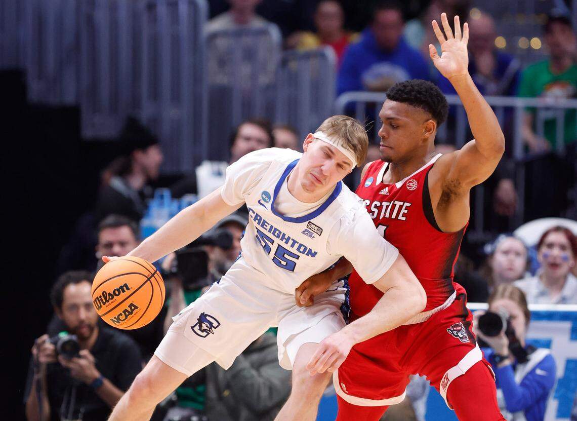 N.C. State’s Casey Morsell (14) defends Creighton’s Baylor Scheierman (55) during the second half of Creighton’s 72-63 victory over N.C. State in the first round of the NCAA Tournament at Ball Arena in Denver, Colo., Friday, March 17, 2023.