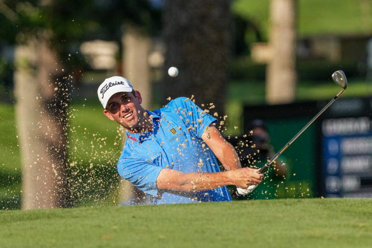 Chesson Hadley hits out of the bunker on 18 during the second round of the Wyndham Championship golf tournament at Sedgefield Country Club.