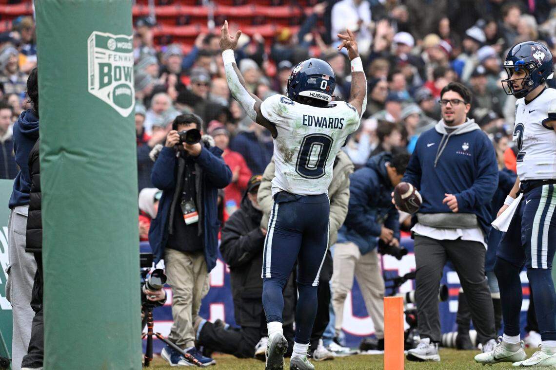 Connecticut Huskies running back Cam Edwards (0) celebrates after scoring a touchdown against the North Carolina Tar Heels during the first half at Fenway Park.
