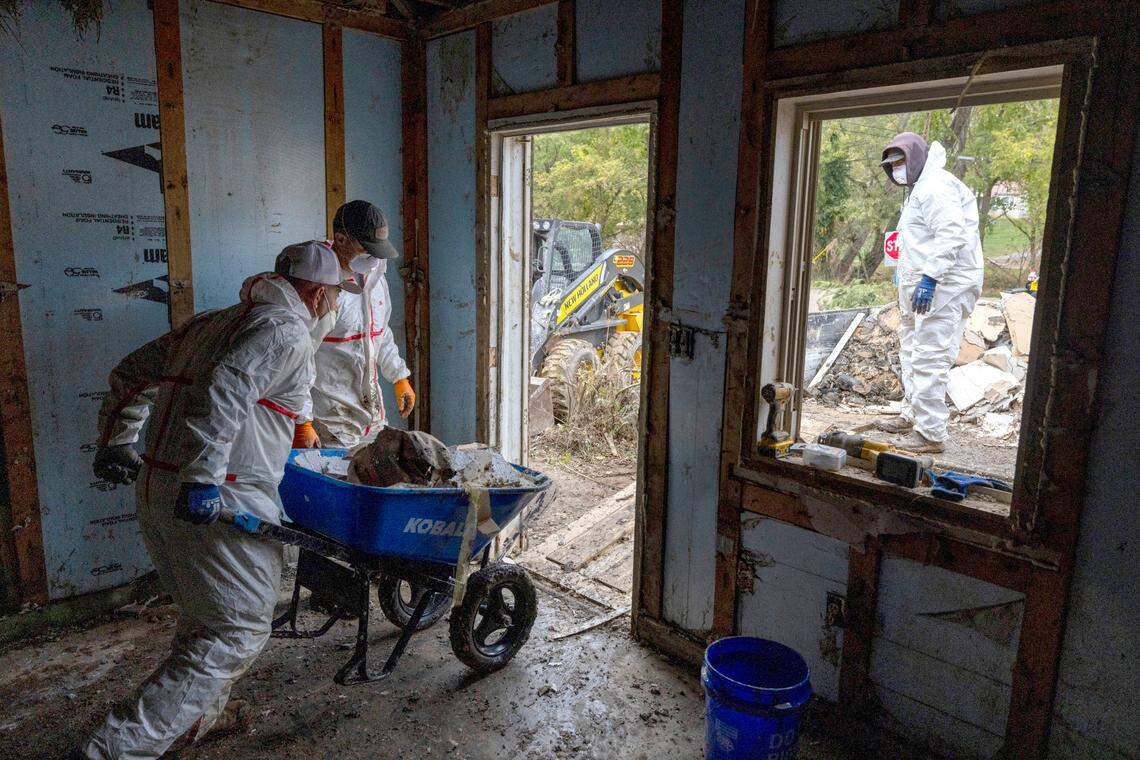 Volunteers from Olive Grove Church, in Clinton, N.C., gut a heavily damaged home on Broad Street in Clyde, N.C., on Wednesday, October 16, 2024. Historic flooding of the Pigeon River in the wake of Hurricane Helene destroyed the home’s interior.