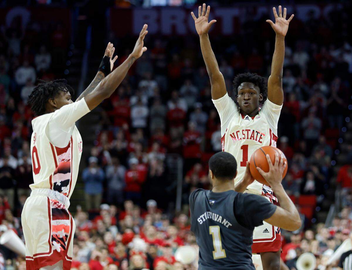 North Carolina State’s Terquavion Smith and Jarkel Joiner pressure Georgia Tech’s Kyle Sturdivant during the second half of a men’s basketball game at PNC Arena on Saturday, Feb. 4, 2023, in Raleigh, N.C.