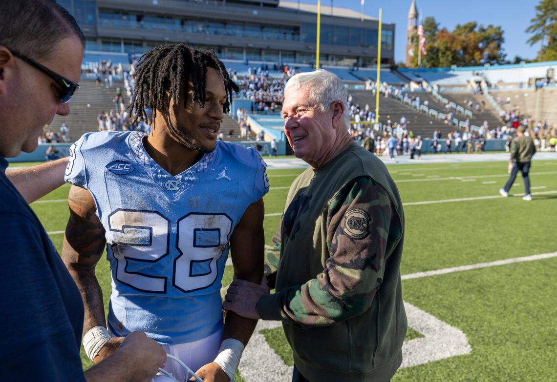 North Carolina coach Mack Brown congratulates Omarion Hampton (28) after he rushed for 144-yards and two touchdown in the Tar Heels’ 59-7 victory over Campbell on Saturday, November 4. 2023 at Kenan Stadium n Chapel Hill, N.C. Hampton has surpassed 1000 yards rushing this season.