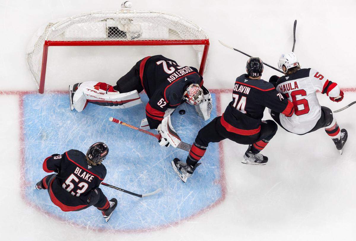 Carolina Hurricanes goalie Pyotr Kochetkov (52) stops a scoring attempt by New Jersey Devils left wing Erik Haula (56) in the first period during Game 5 of their Stanely Cup series on Tuesday, April 29, 2025 at Lenovo Center in Raleigh, N.C.