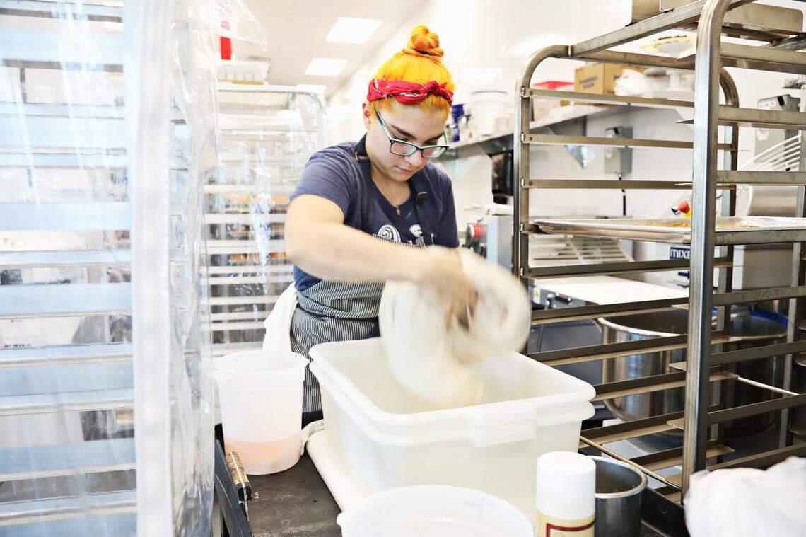 Union Special Bread head baker Maria Luna works in the kitchen on Wednesday, Aug. 7, 2019, as the bakery prepares for its grand opening.
