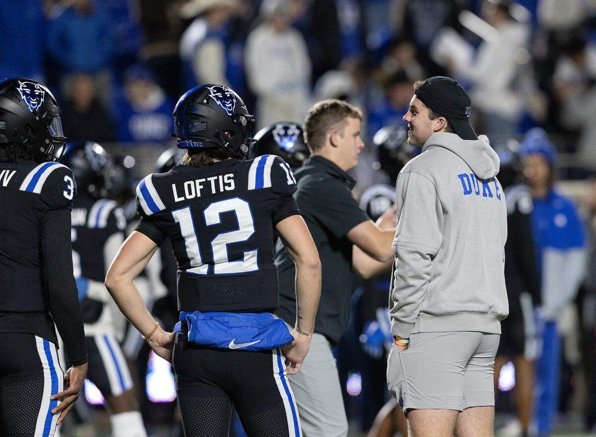 Duke quarterbacks Grayson Loftis and Riley Leonard stand on the field during warm-ups prior to the Blue Devils’ game against Wake Forest on Thursday, Nov. 2, 2023, at Wallace Wade Stadium in Durham, N.C.