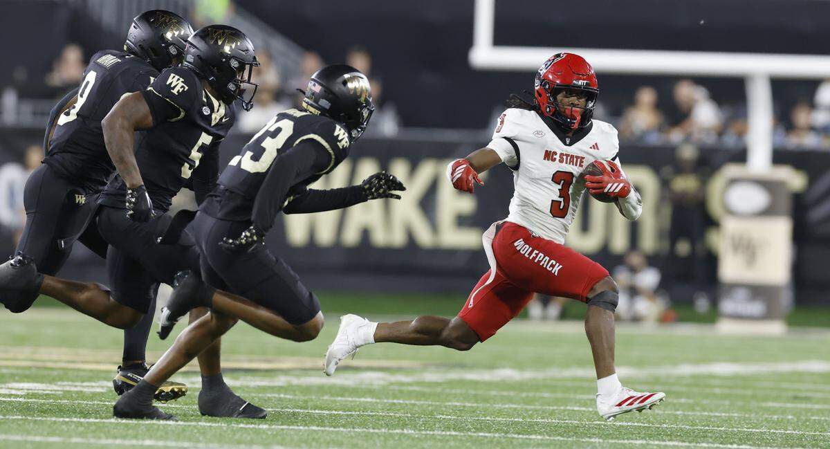 N.C. State running back Hollywood Smothers (3) tries to break free from Wake Forest defenders during the second half of N.C. State’s 34-24 victory over Wake Forest at Allegacy Stadium in Winston-Salem, N.C., Thursday, Sept. 11, 2025.