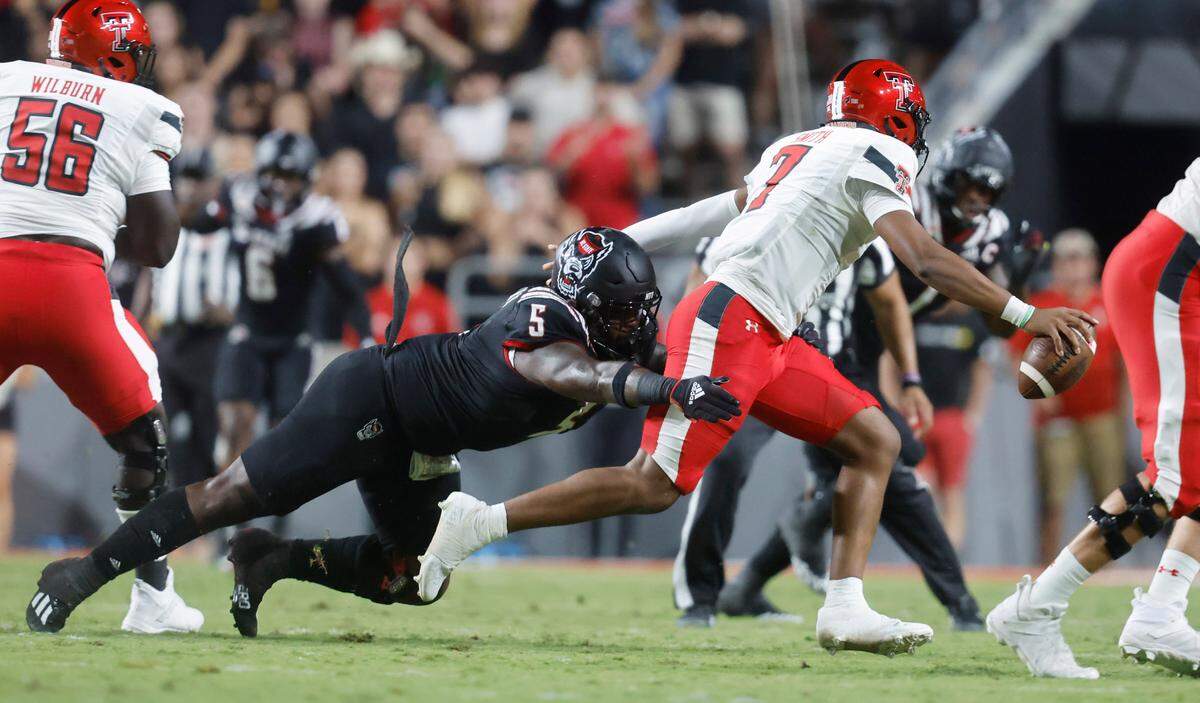 N.C. State defensive tackle C.J. Clark (5) sacks Texas Tech quarterback Donovan Smith (7) during the first half of N.C. State’s game against Texas Tech at Carter-Finley Stadium in Raleigh, N.C., Saturday, Sept. 17, 2022.