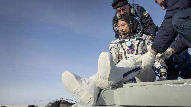 NASA astronaut Christina Koch is helped out of the Soyuz MS-13 spacecraft just minutes after the capsule landed in a remote area near the town of Zhezkazgan, Kazakhstan on Feb. 6, 2020. Koch returned to Earth after logging 328 days in space, the longest spaceflight in history by a woman. 