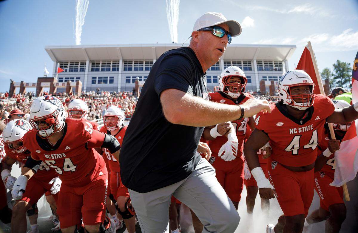N.C. State head coach Dave Doeren takes the field with his players before the Wolfpack’s game against Campbell on Oct. 4 at home.