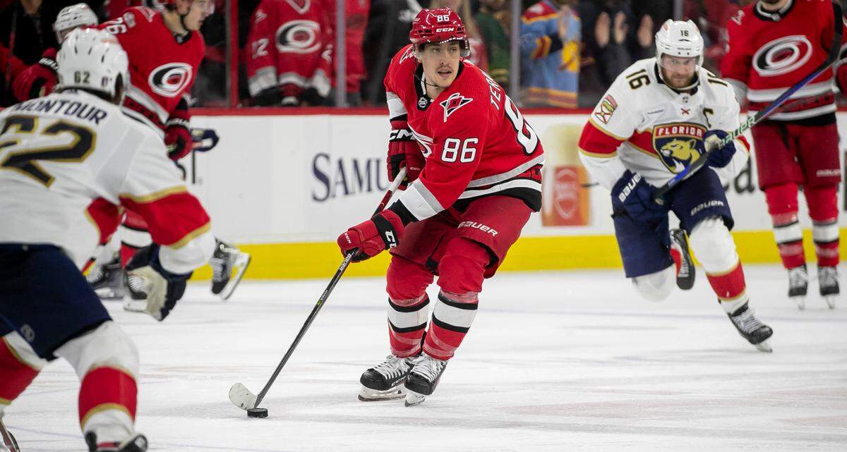 The Carolina Hurricanes Teuvo Teravainen (86) moves the puck between the Florida Panthers Brandon Montour (62) and Aleksander Barkov (16) in the fourth overtime period in Game 1 of the Eastern Conference Finals on Friday, May 19, 2023 at PNC Arena in Raleigh. Teravainen saw his first playoff action in a month after recovering from a broken hand.