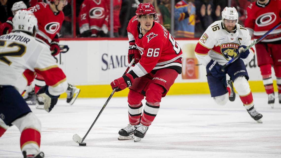 The Carolina Hurricanes Teuvo Teravainen (86) moves the puck between the Florida Panthers Brandon Montour (62) and Aleksander Barkov (16) in the fourth overtime period in Game 1 of the Eastern Conference Finals on Friday, May 19, 2023 at PNC Arena in Raleigh. Teravainen saw his first playoff action in a month after recovering from a broken hand.