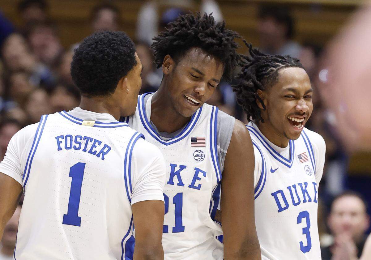Duke’s Caleb Foster (1) and Isaiah Evans (3) celebrate with Patrick Ngongba II (21) in the second half of Duke’s 83-52 victory over Louisville at Cameron Indoor Stadium in Durham, N.C., Monday, Jan. 26, 2026.