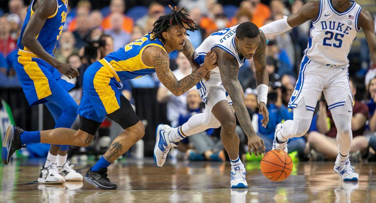 Duke’s Dariq Whitehead (0) makes a steal from Pittsburgh’s Nike Sibande (22) in the first half during the third round of the ACC Tournament on Thursday, March 9, 2023 at the Greensboro Coliseum in Greensboro, N.C.