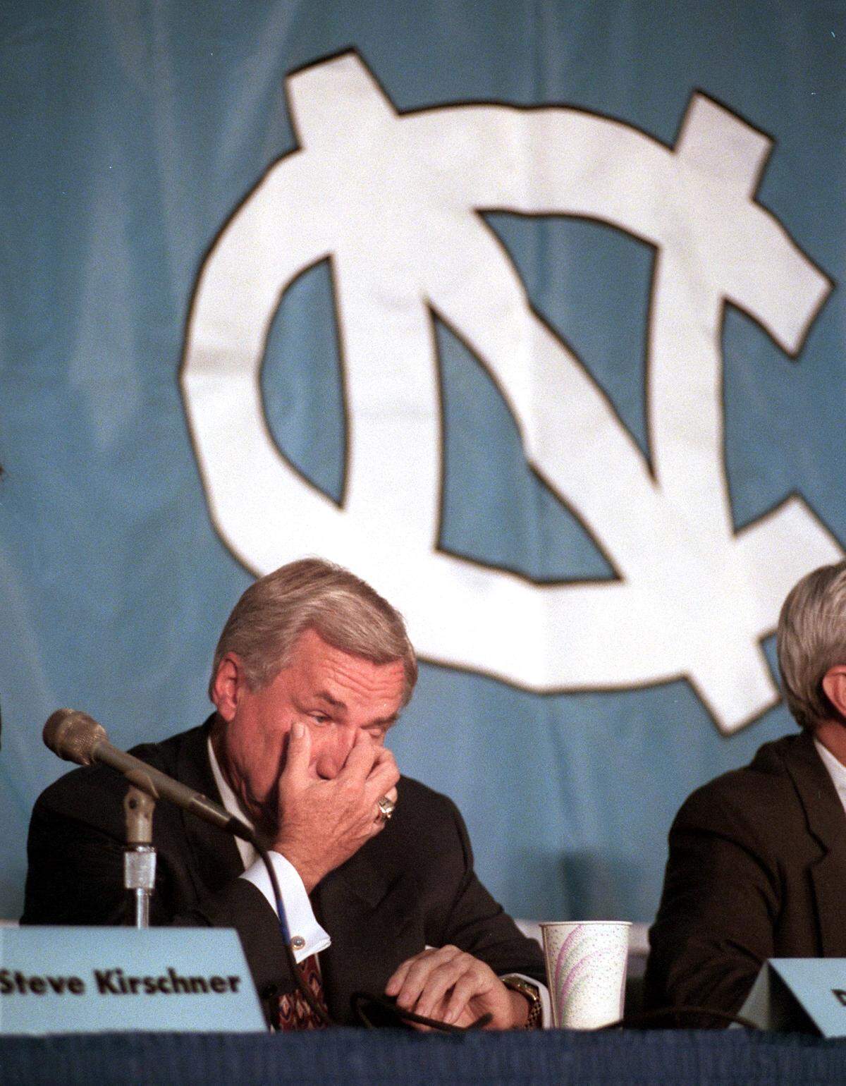 UNC'S Dean Smith wipes a tear away during an emotional moment early in his press conference announcing his resignation at head basketball coach at UNC in 1997.