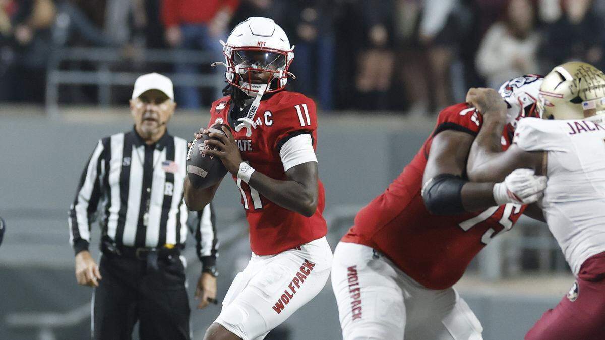N.C. State quarterback CJ Bailey (11) looks for a receiver downfield during the first half of N.C. State’s game against Florida State at Carter-Finley Stadium in Raleigh, N.C., Friday, Nov. 21, 2025.