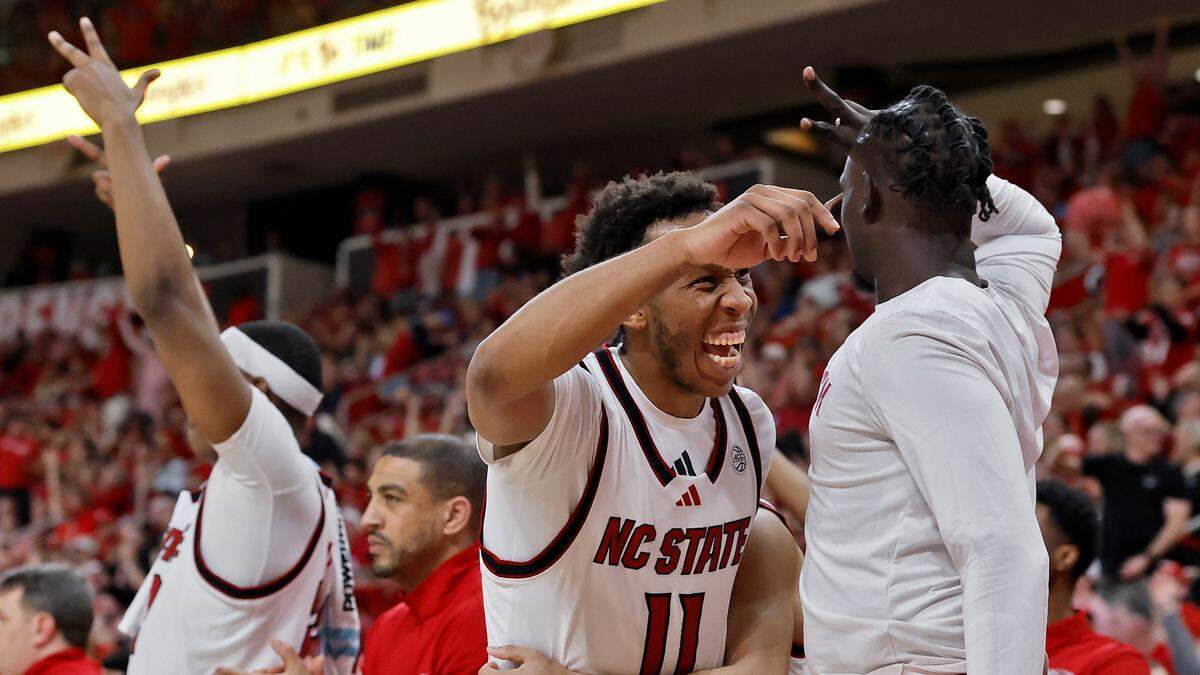 N.C. State’s Quadir Copeland reacts on the bench following a basket by Terrance Arceneaux during the second half of the Wolfpack’s 82-58 win over North Carolina on Tuesday, Feb. 17, 2026, at Lenovo Center in Raleigh, N.C.