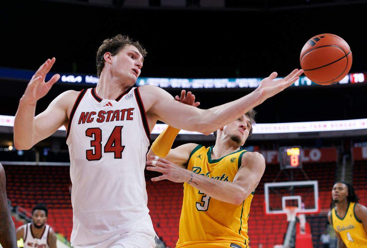 N.C. State’s Ben Middlebrooks and Lees-McRae’s Brandon Brown vie for a loose ball during the second half of the Wolfpack’s 79-75 exhibition win on Wednesday, Oct. 30, 2024, at the Lenovo Center.