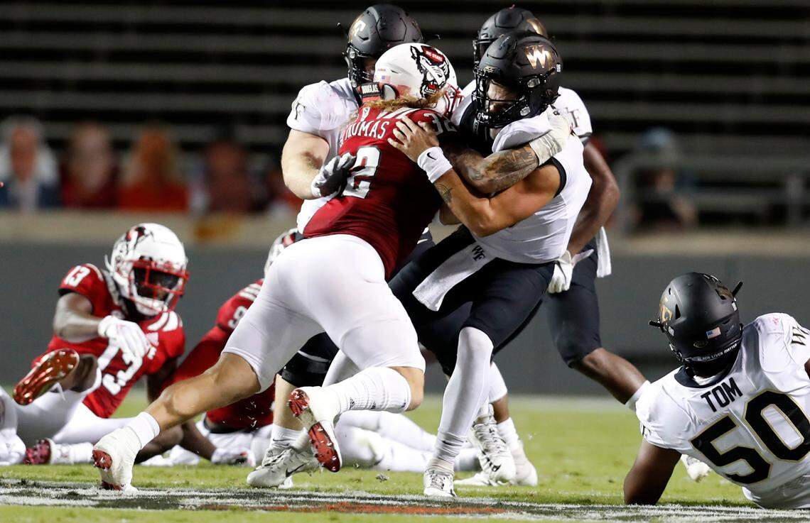 N.C. State linebacker Drake Thomas (32) sacks Wake Forest quarterback Sam Hartman (10) during the first half of N.C. State’s game against Wake Forest at Carter-Finley Stadium in Raleigh, N.C, Saturday, Sept. 19, 2020.