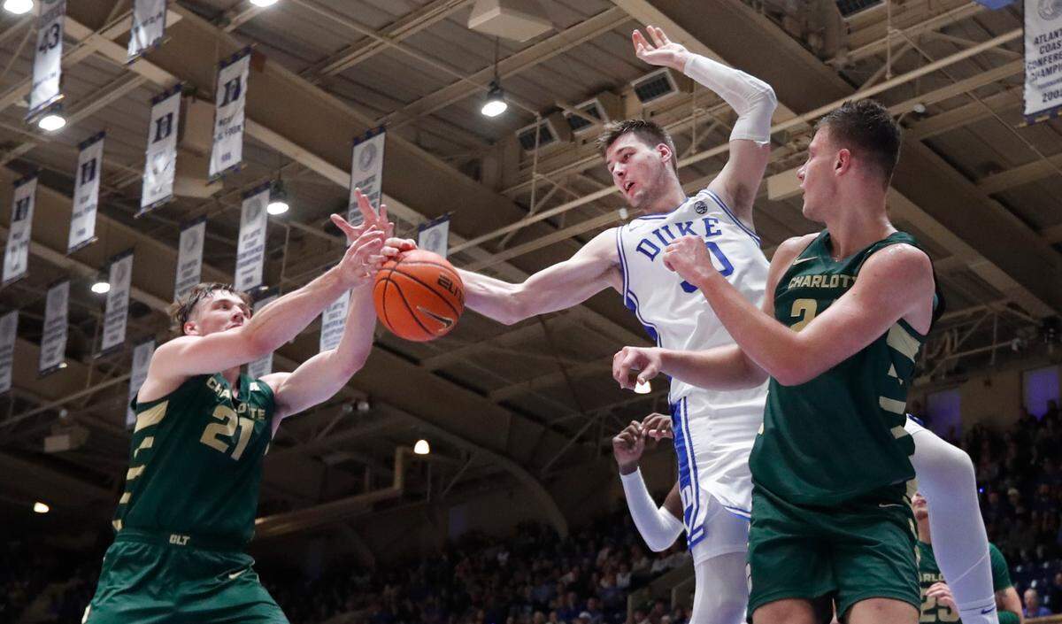 Duke’s Kyle Filipowski (30) goes for the rebound with Charlotte’s Dean Reiber (21), left, and Igor Milicic Jr. (24) during Duke’s 80-56 victory over Charlotte at Cameron Indoor Stadium in Durham, N.C., Saturday, Dec. 9, 2023.