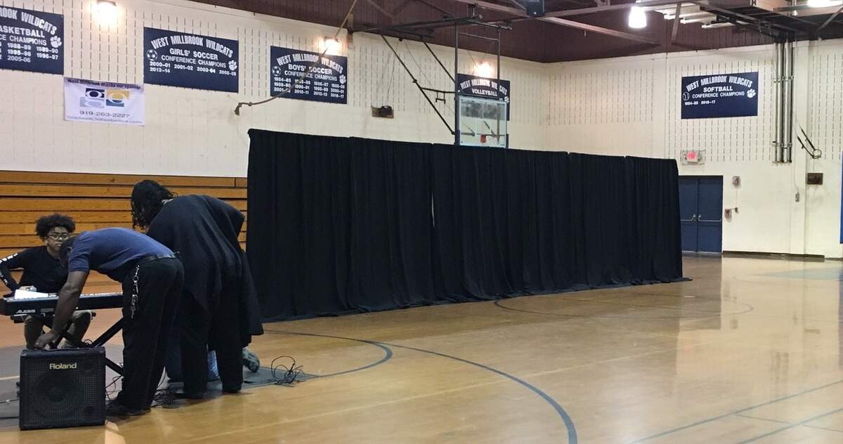 Some parent volunteers at West Millbrook Middle School in Raleigh, N.C., try to get the gym ready for a talent show because there's no auditorium. Parents and students say the gym looks poor compared to what's found  at other Wake County middle schools.