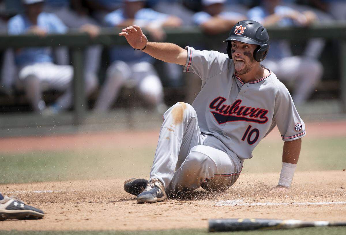 Auburn’s Edouard Julien (10) reacts as he slides safely into home plate on a single by Kason Howell in the first inning against North Carolina to give Auburn a 4-0 lead during the NCAA Super Regional on Monday, June 10, 2019 at Boshamer Stadium in Chapel Hill, N.C.