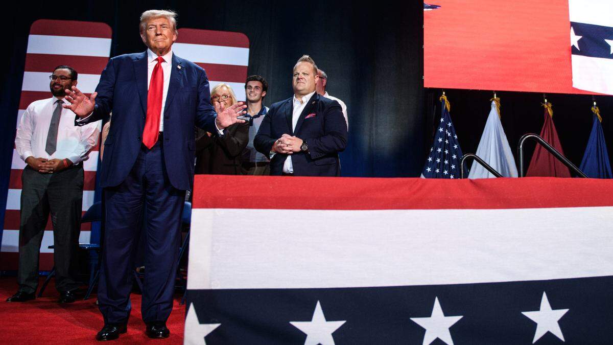 Republican presidential nominee and former U.S. President Donald Trump does a little dance as he gets on stage at a town hall event at the Crown Arena on Friday, October. 4, 2024.