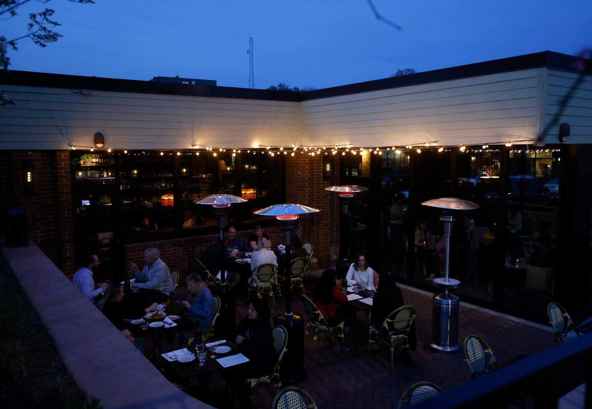 Patrons dine on the patio at Hank’s Downtown Dive on Thursday, March 16, 2023, in Cary, N.C.