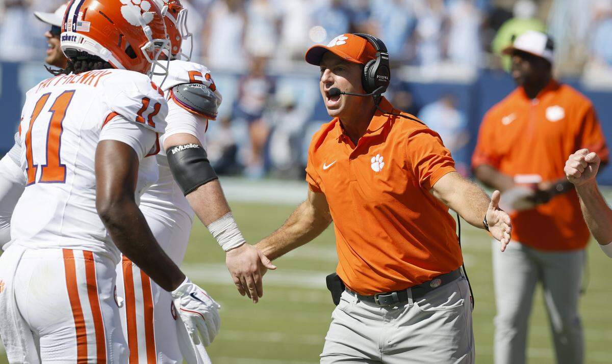 Clemson head coach Dabo Swinney celebrates with the team after they scored during the first half of UNC’s game against Clemson at Kenan Stadium in Chapel Hill, N.C., Sat. Oct. 4, 2025.