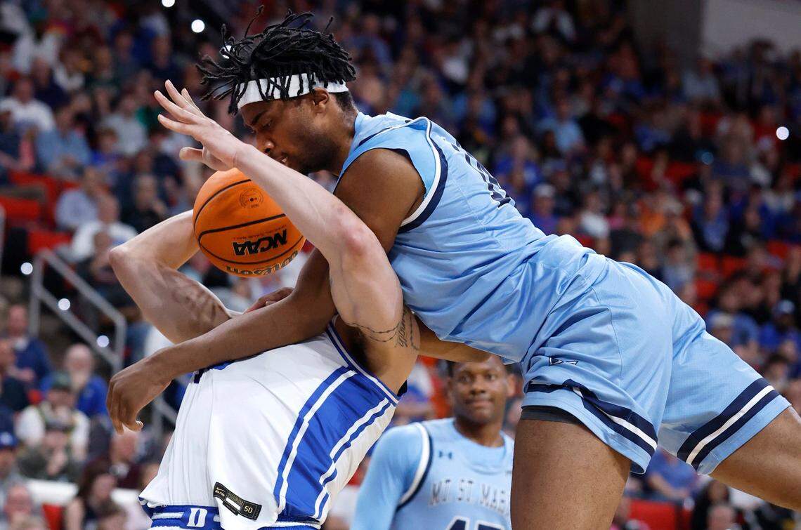 Mount St. Mary’s Jedy Cordilia (14) fouls Duke’s Mason Gillis (18) during the first half of Duke’s game against Mount St. Mary’s in the first round of the 2025 NCAA Men’s Basketball Tournament at the Lenovo Center in Raleigh, N.C., Friday, March 21, 2025.