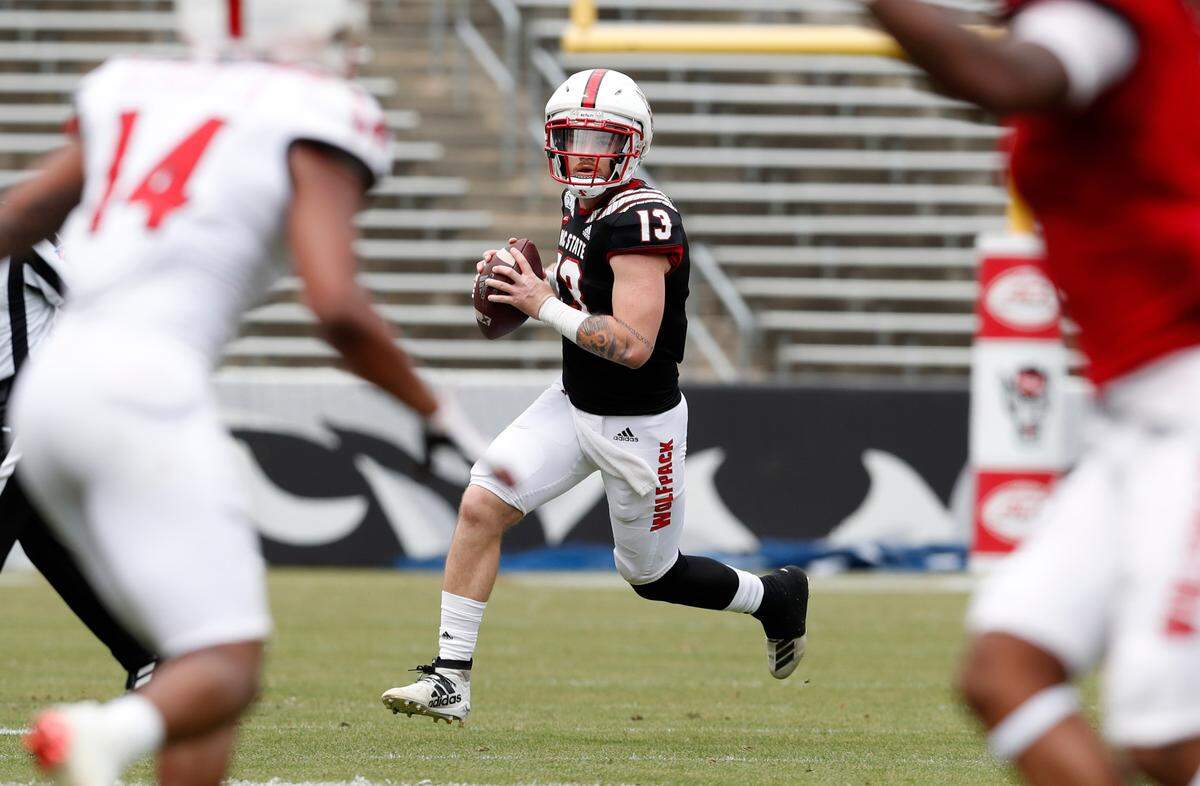 N.C. State quarterback Devin Leary (13 looks for a receiver downfield during the first half of N.C. State football’s spring game at Carter-Finley Stadium in Raleigh, N.C., Saturday, April 10, 2021.