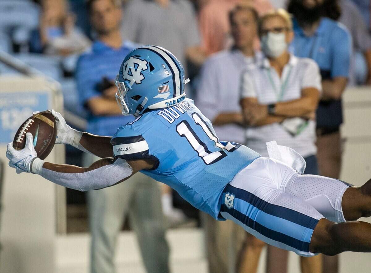 North Carolina’s Josh Downs (11) makes a diving catch for a 37-yard touchdown on a pass from quarterback Sam Howell to give the Tar Heels’ a 14-0 lead over Virginia in the first quarter on Saturday, September 18, 2021 at Kenan Stadium in Chapel Hill, N.C.